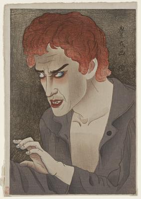 man with wrinkled brow, curly red hair, wearing grey shirt; dark grey ground